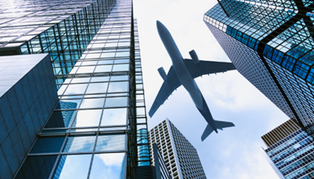 Plane flying over buildings