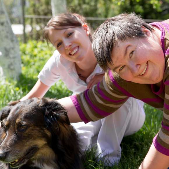 Woman and dog with developmentally challenged adult