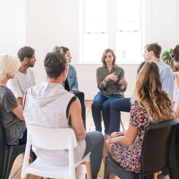 group of adults in a circle talking